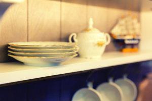 White plates and dinnerware in a cupboard